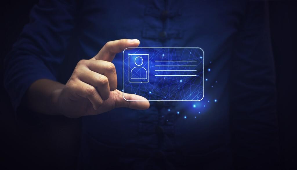 Kuvituskuva, jossa henkilö pitää kädessään digitaalista henkilökorttia.